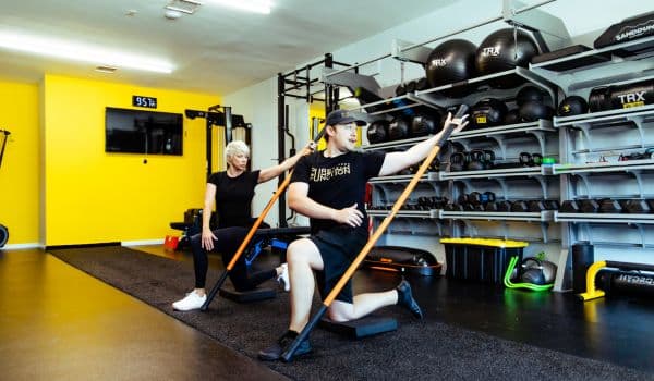corrective exercise being demonstrated by trainer from pure function woodland hills