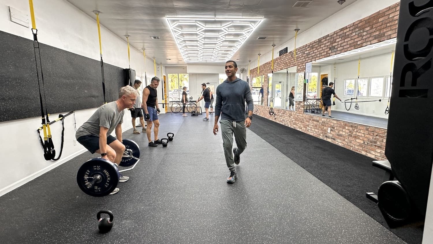 A coached group class in progress on the Pure Function training floor