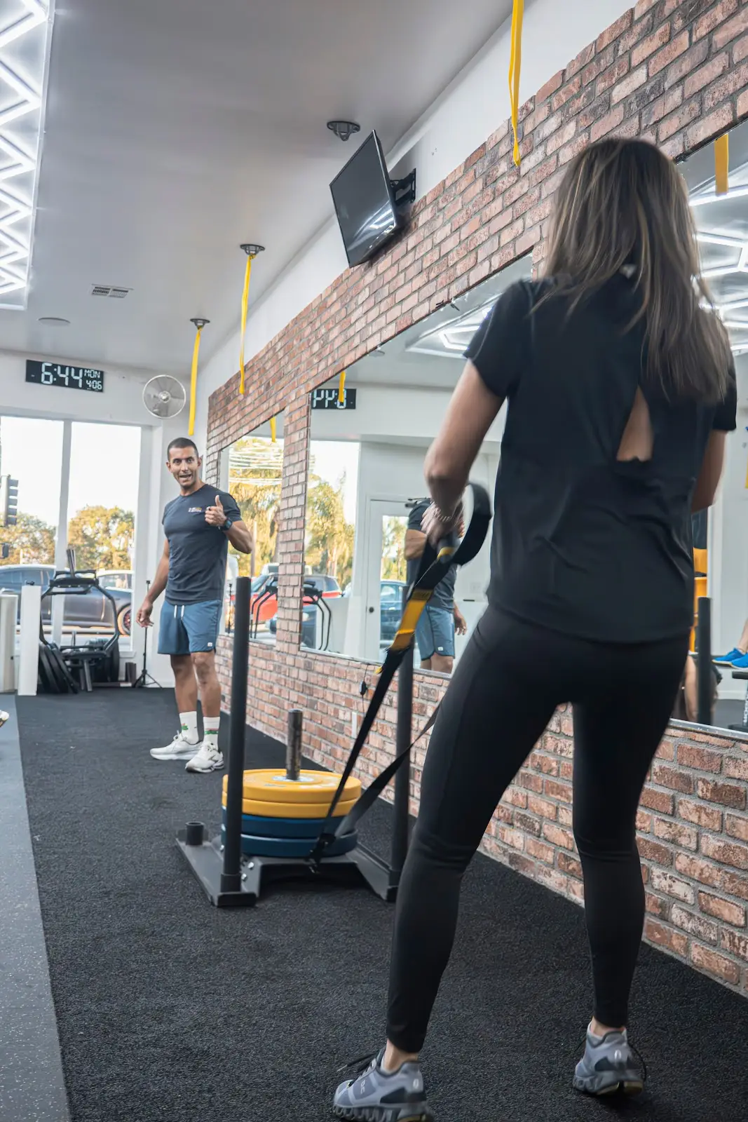 A sled push along the mirror wall during a strength and conditioning class