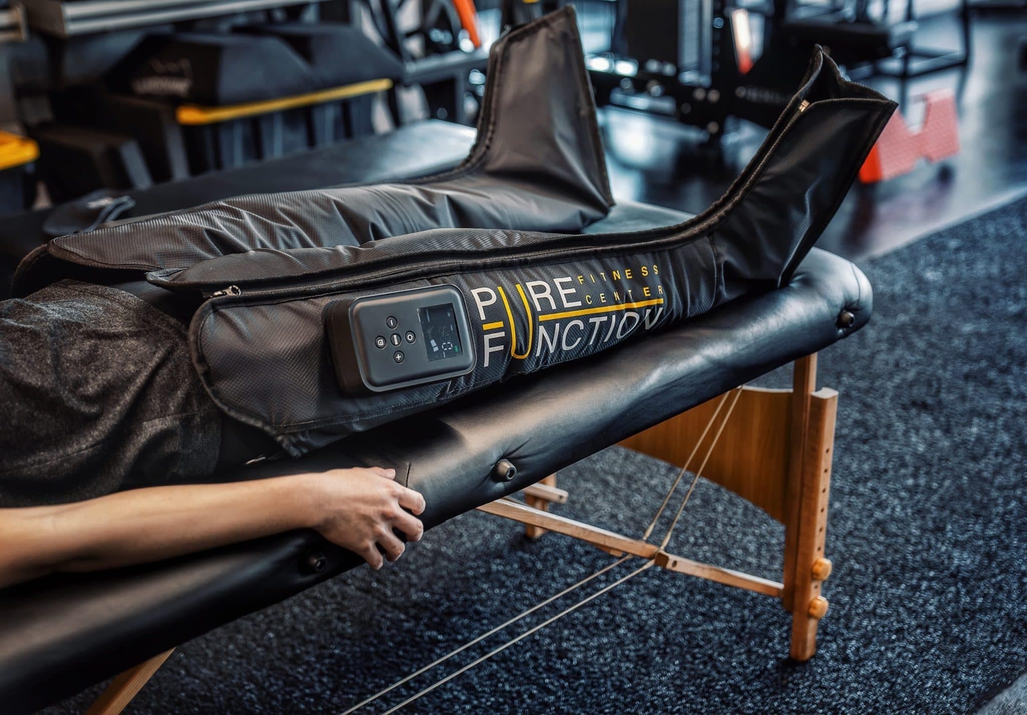 A client on the therapy table in Pure Function compression recovery boots