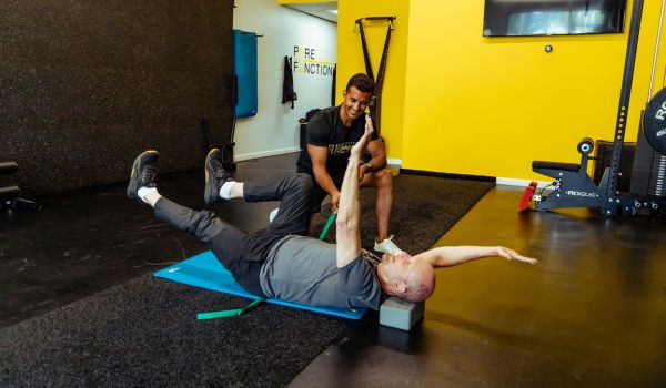 dead bug exercise being demonstrated by a beginner